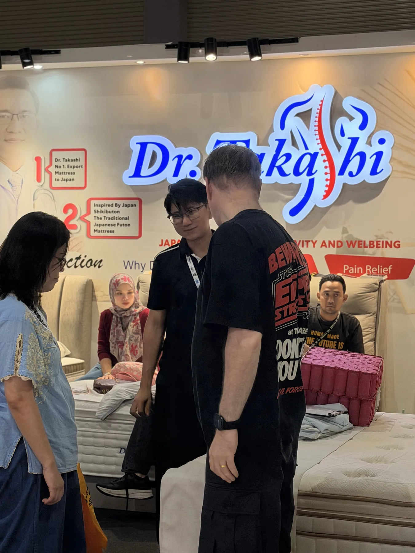 Customers speaking with the Dr. Takashi team at an exhibition in Malaysia.